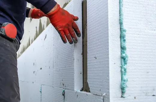 Rigid foam boards fitted to a wall with foam-sealed seams